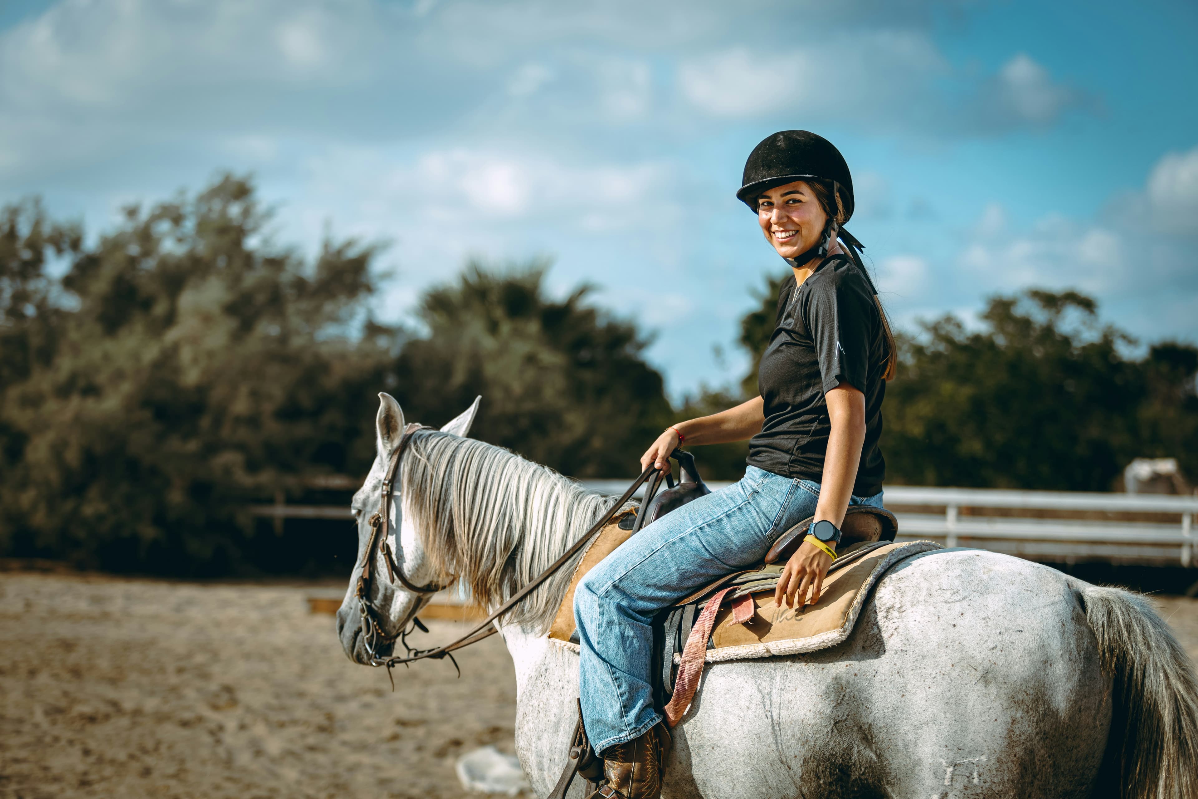 Rider mounted on a horse during a schooling session.